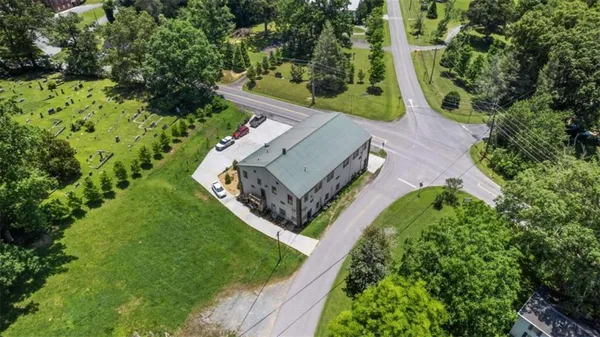 an aerial view of a house with a yard