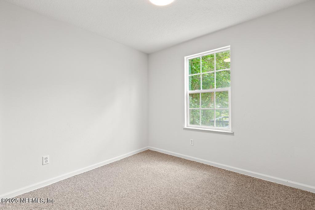 3701 Stuart Street Jacksonville, FL 32209 - Photo 16 of 24 an empty room with a window