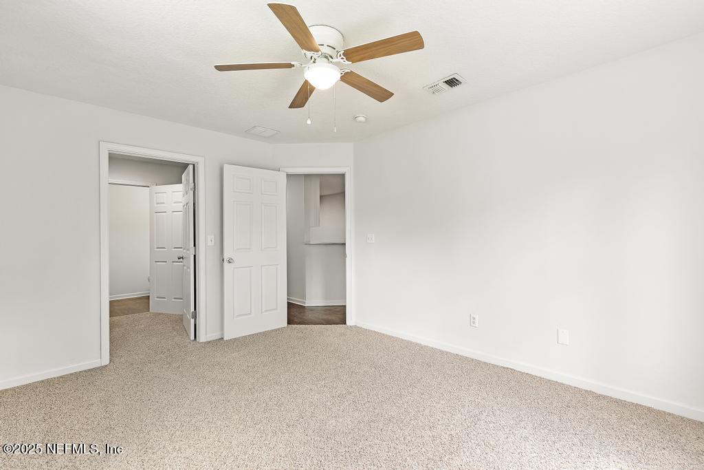 3701 Stuart Street Jacksonville, FL 32209 - Photo 19 of 24 an empty room with a ceiling fan and a fan
