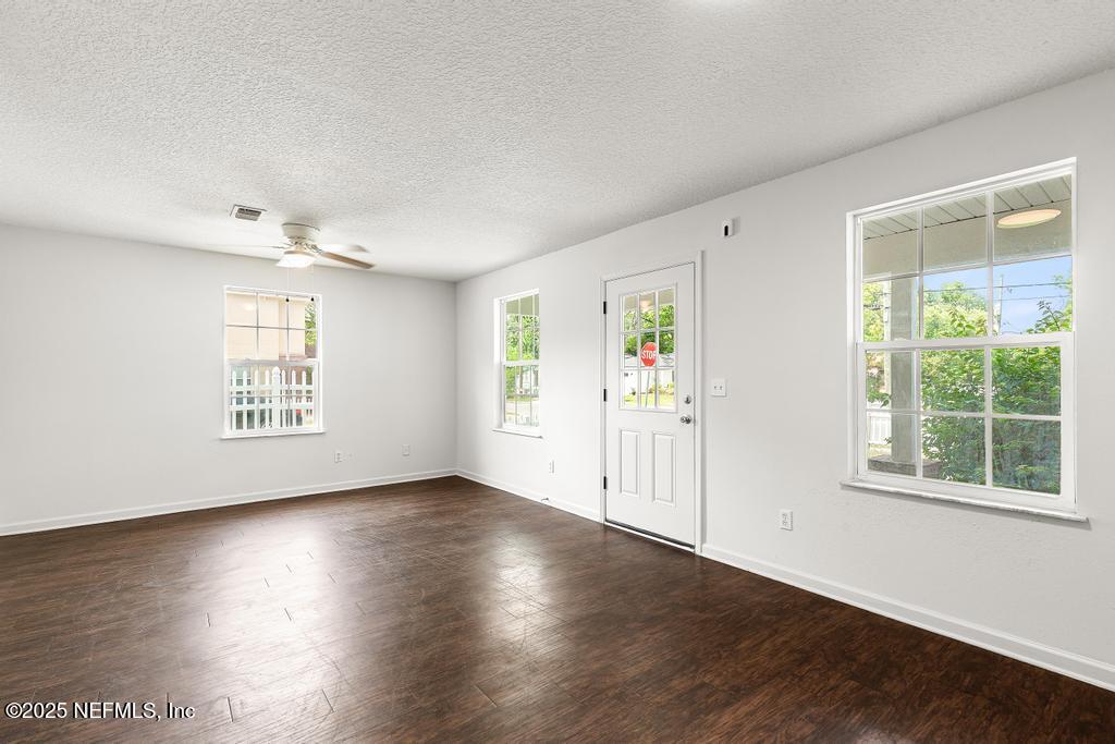 3701 Stuart Street Jacksonville, FL 32209 - Photo 4 of 24 an empty room with wooden floor and windows