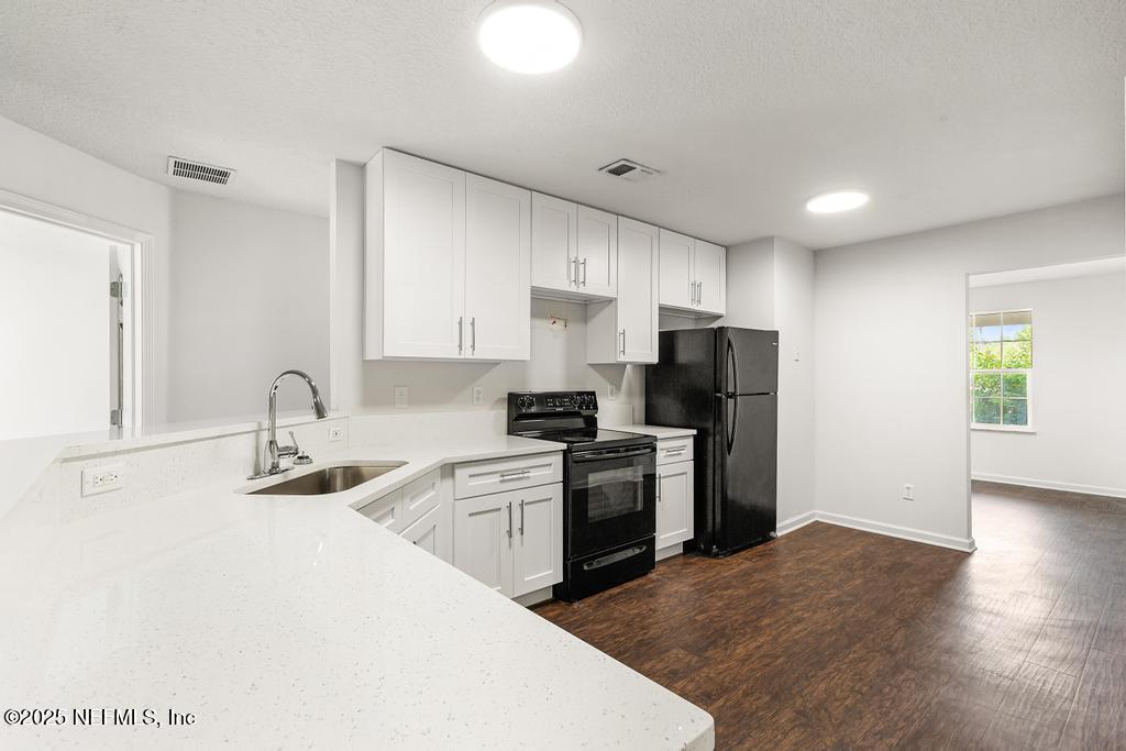 3701 Stuart Street Jacksonville, FL 32209 - Photo 9 of 24 a kitchen with kitchen island a sink stainless steel appliances and cabinets