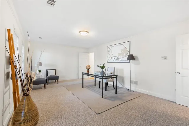 a work room with furniture and a flat screen tv