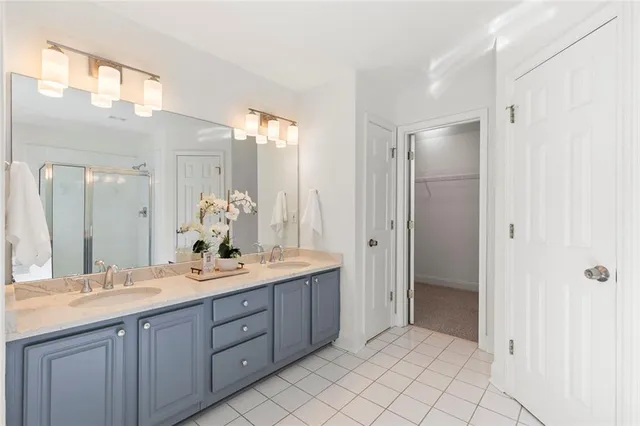 a spacious bathroom with a double vanity sink mirror and double