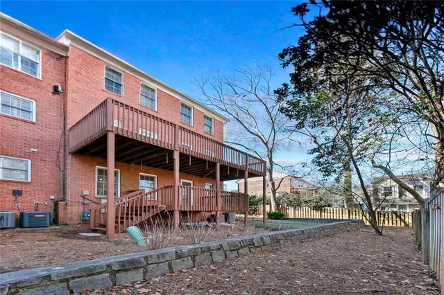 a view of a house with a yard and hanging chair