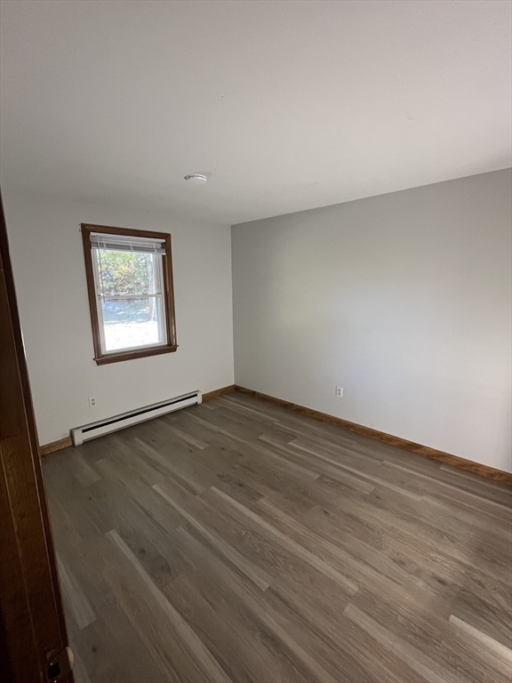 35 School Street, Unit 7 Dracut, MA 01826 - Photo 15 of 22 an empty room with wooden floor and windows
