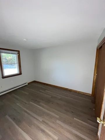 a view of an empty room and wooden floor
