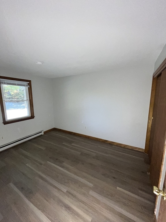 35 School Street, Unit 7 Dracut, MA 01826 - Photo 17 of 22 a view of an empty room and wooden floor