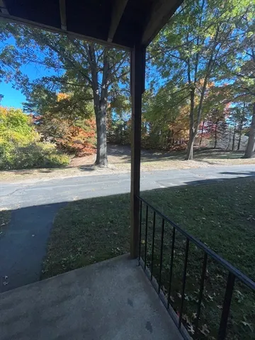 a view of a yard with wooden fence