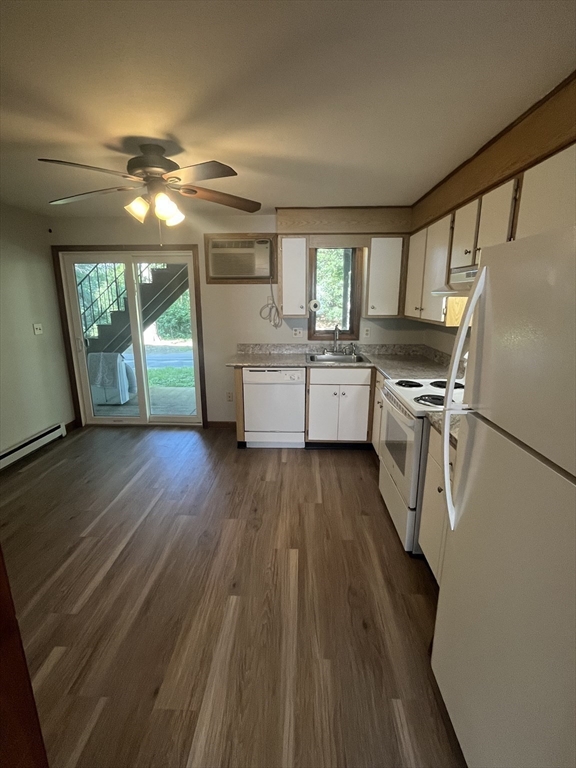35 School Street, Unit 7 Dracut, MA 01826 - Photo 3 of 22 a kitchen with wooden floors and refrigerator