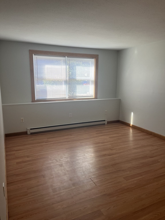 35 School Street, Unit 7 Dracut, MA 01826 - Photo 6 of 22 wooden floor in an empty room with a window