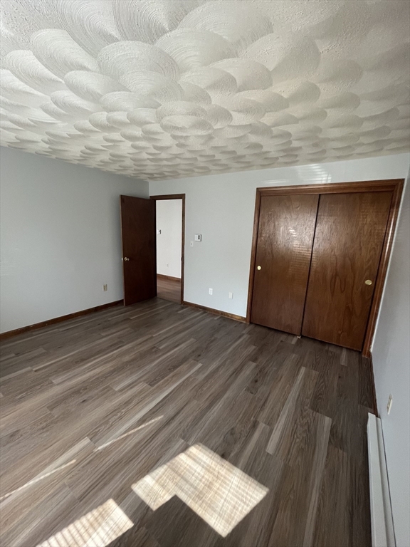 35 School Street, Unit 7 Dracut, MA 01826 - Photo 10 of 22 a view of an empty room with wooden floor