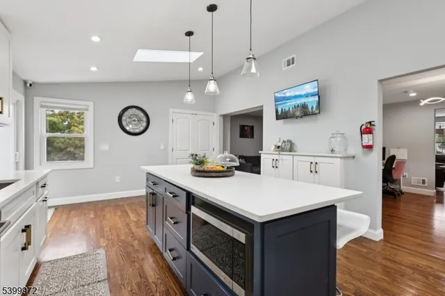 a kitchen with a sink a stove and chairs