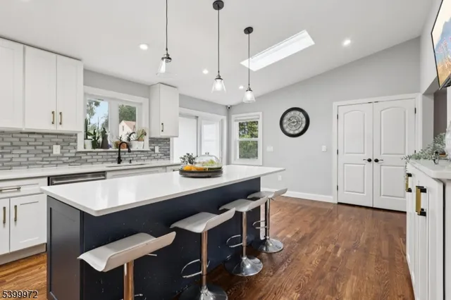 a kitchen with a table chairs sink and cabinets