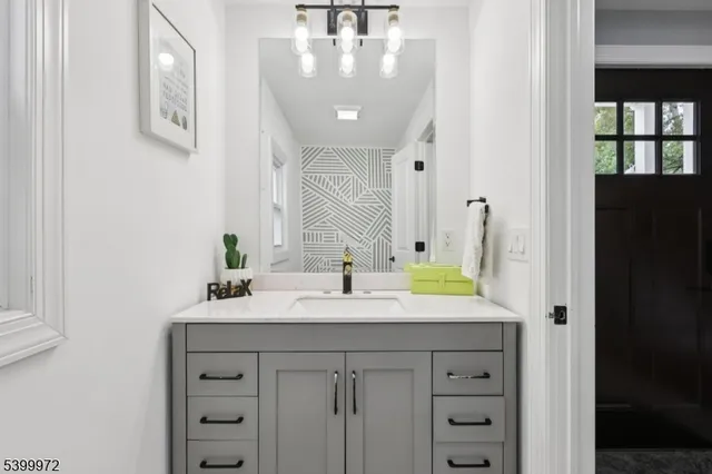 a bathroom with a sink vanity and a mirror