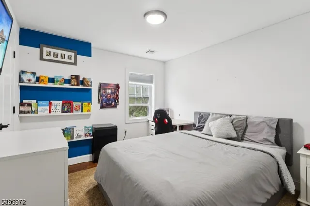 a bedroom with a bed and a book shelf