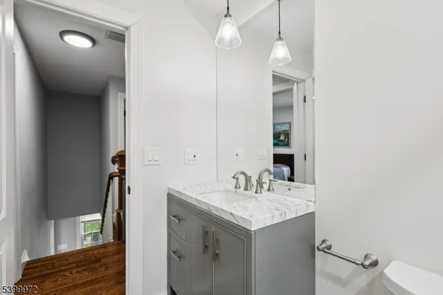 a bathroom with a sink vanity and a mirror