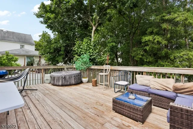 a view of a deck with chairs a barbeque with wooden floor and fence