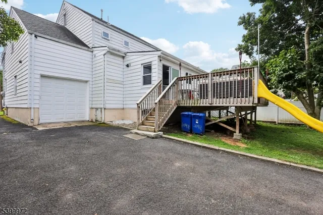 a view of wooden deck with chairs and a yard