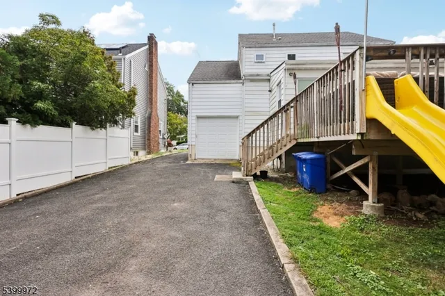 a view of a house with wooden floor and a fence