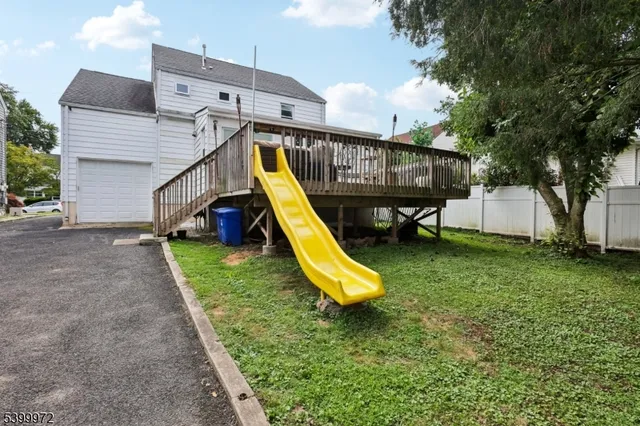 a view of a backyard with a slide and a slide