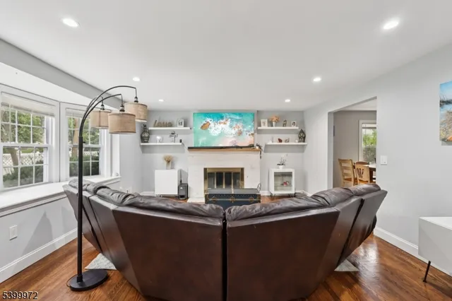 a living room with furniture a fireplace and a large window