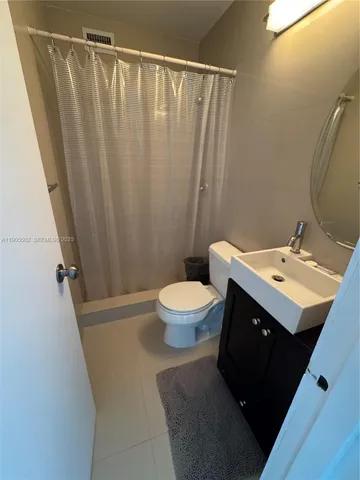 a white toilet sitting next to a small sink