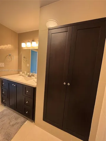 a view of a hallway with wooden floor and stairs