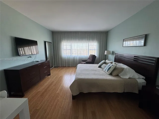 a view of a workspace with wooden floor