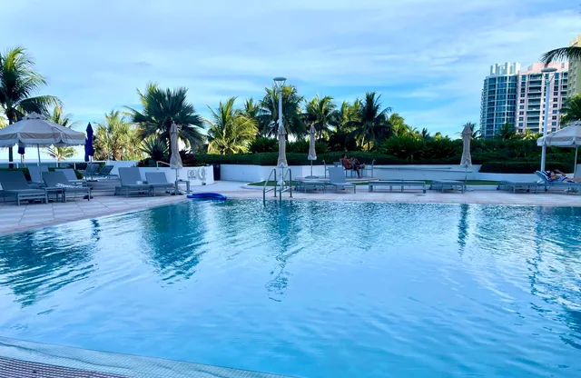 a view of swimming pool with outdoor seating and plants