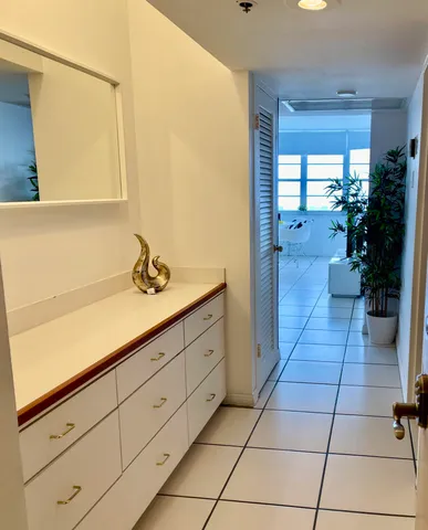 a spacious bathroom with a sink a mirror and a shower