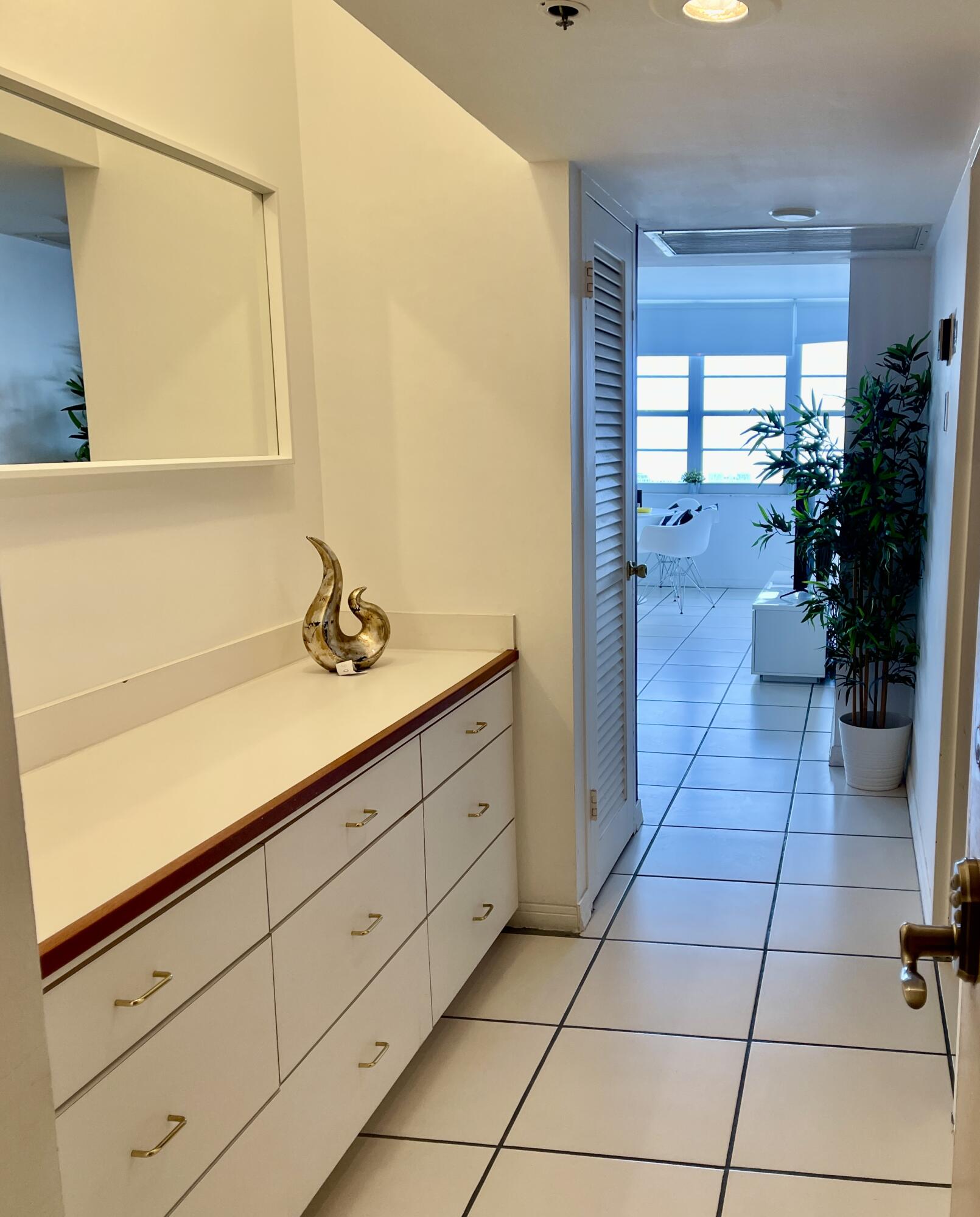 100 Lincoln Road, Unit 1105 Miami Beach, FL 33139 - Photo 16 of 30 a spacious bathroom with a double vanity sink and a mirror