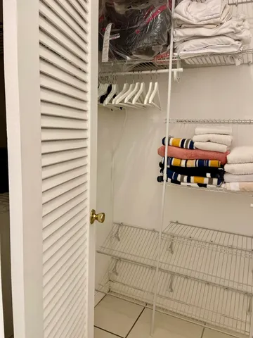 a bathroom with a double vanity sink and mirror with toilet