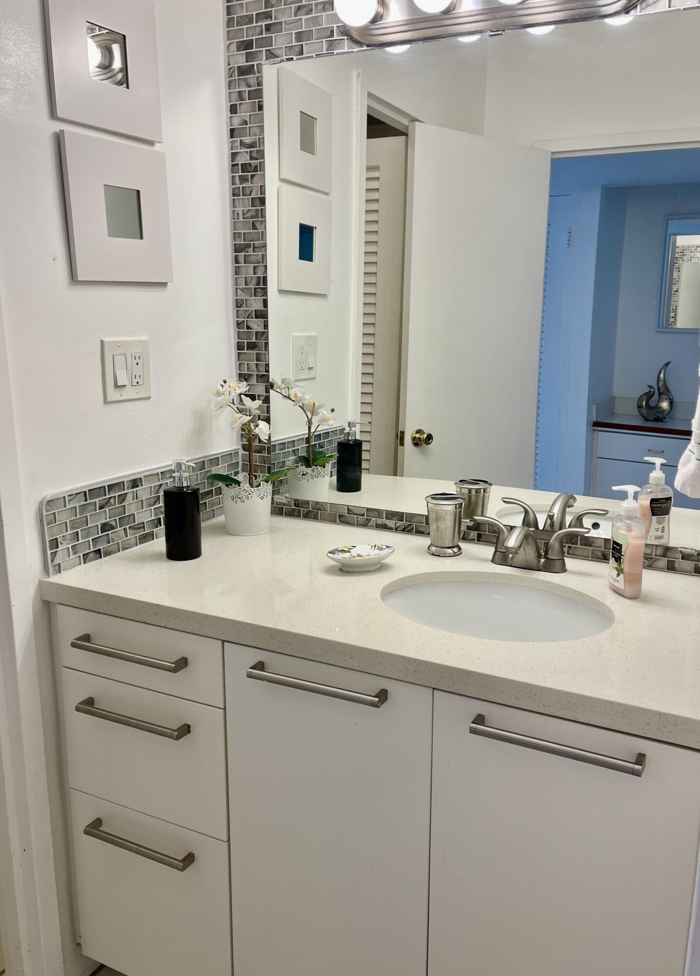 100 Lincoln Road, Unit 1105 Miami Beach, FL 33139 - Photo 20 of 30 a bathroom with a sink and a mirror