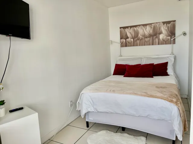 a living room with a flat screen tv and a window