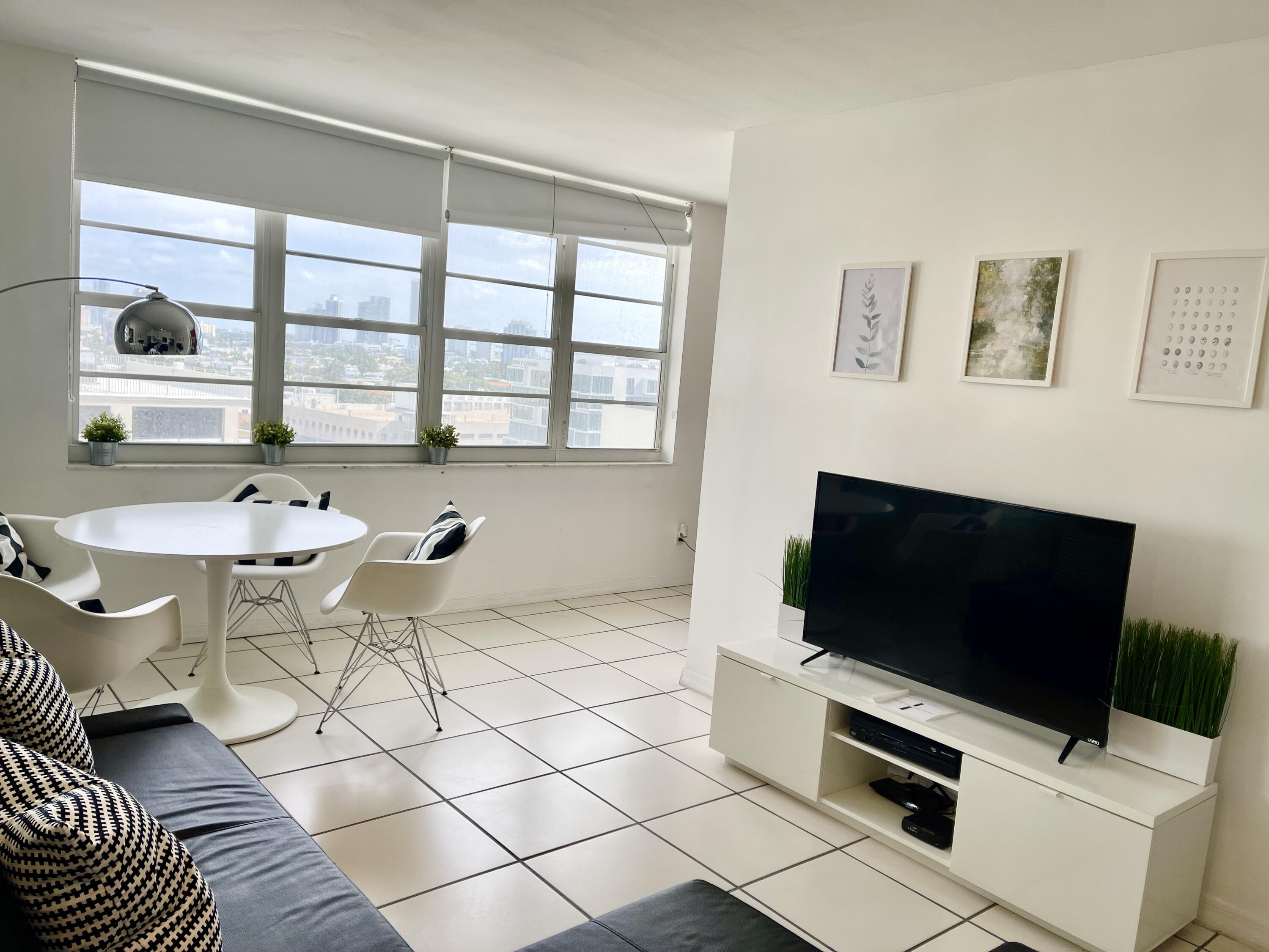 100 Lincoln Road, Unit 1105 Miami Beach, FL 33139 - Photo 26 of 30 a living room with a flat screen tv and a window
