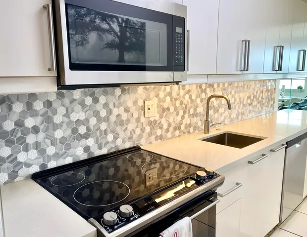 a kitchen with a sink cabinets and a wooden floor