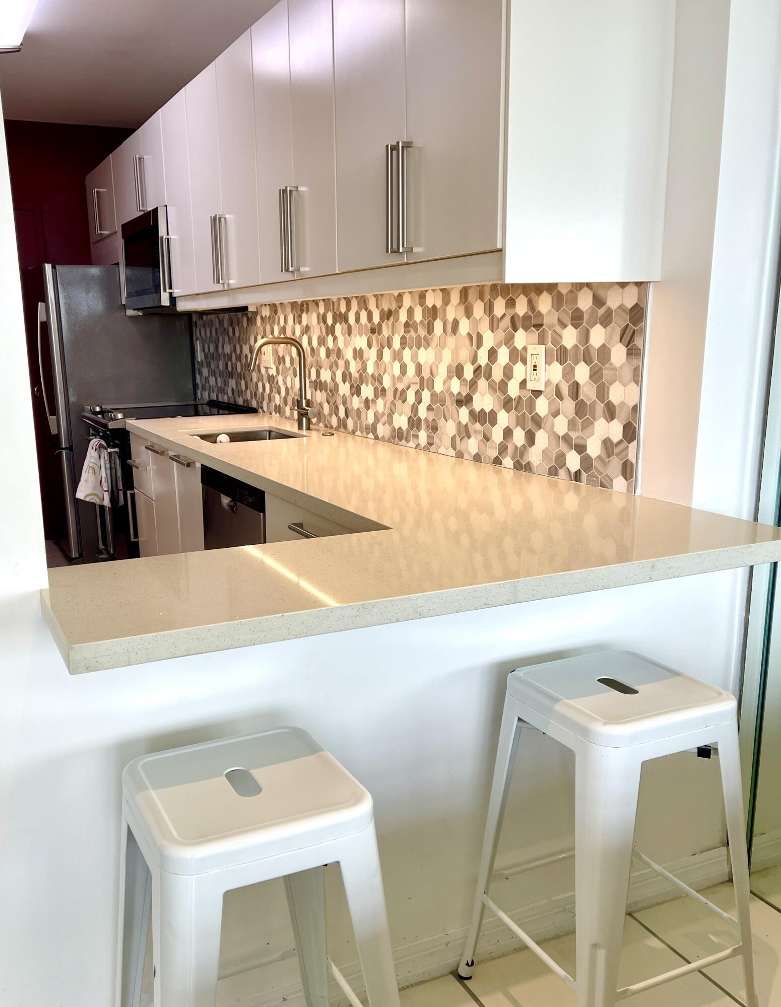 100 Lincoln Road, Unit 1105 Miami Beach, FL 33139 - Photo 29 of 30 a kitchen with a sink cabinets and a wooden floor