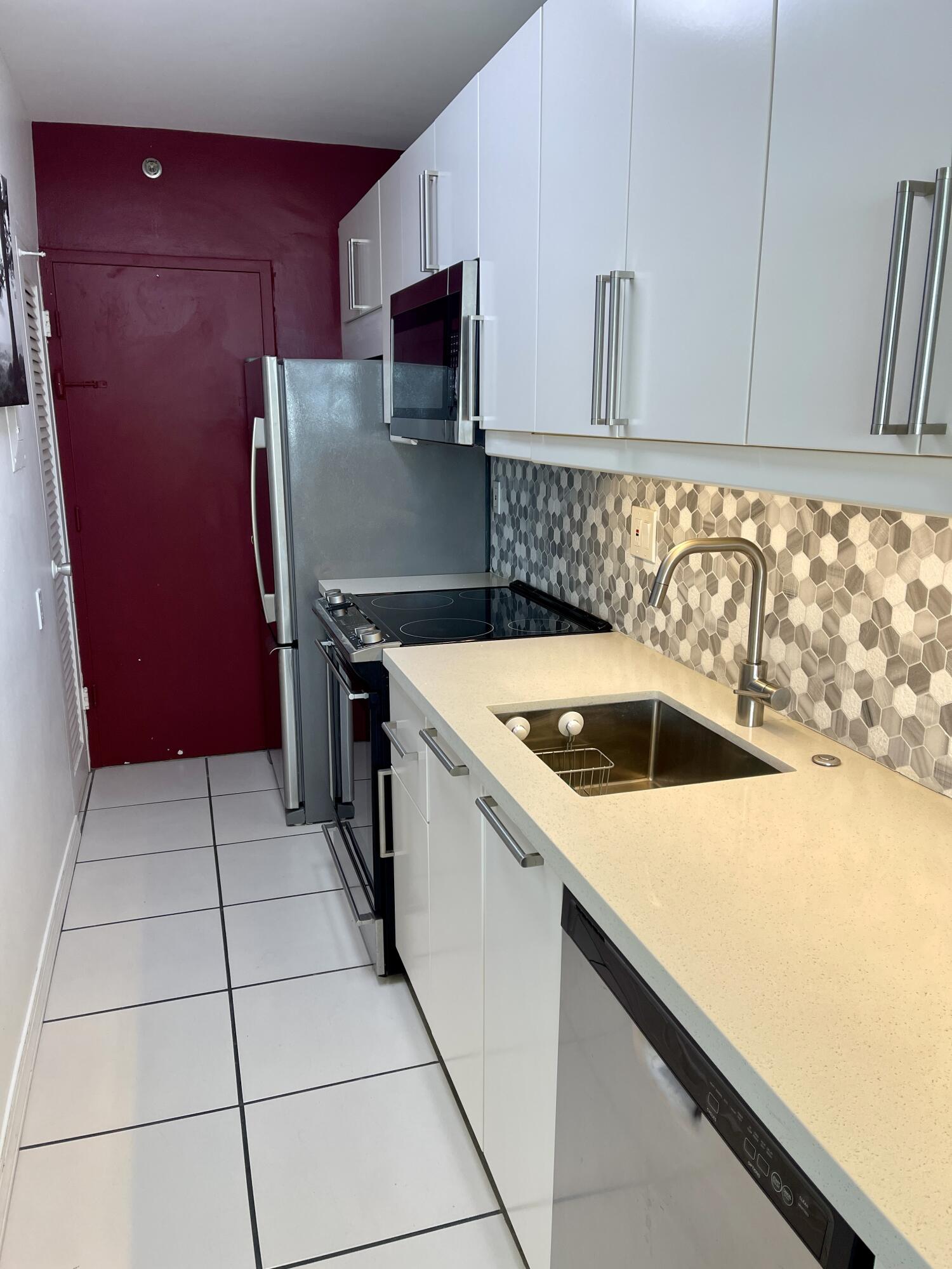 100 Lincoln Road, Unit 1105 Miami Beach, FL 33139 - Photo 30 of 30 a kitchen with a sink a stove and a microwave