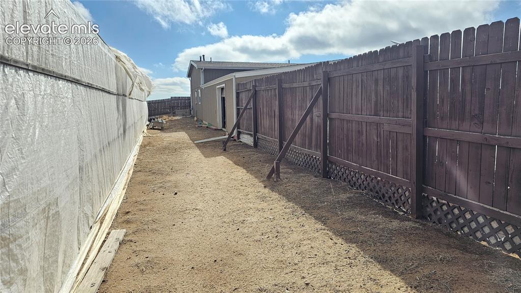 3835 Sengbeil Road Yoder, CO 80864 - Photo 4 of 48 a view of a backyard with wooden fence