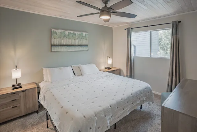 a bedroom with a large bed and a chandelier