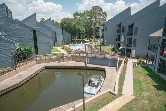 a small pool with a table and chairs in front of it