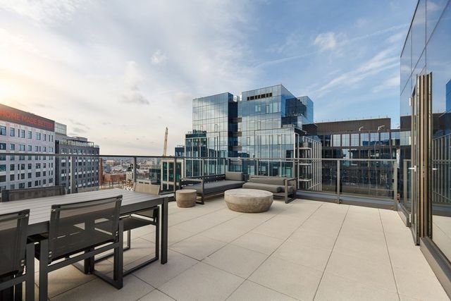 a living room with furniture and large windows