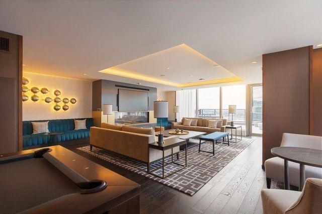 a living room with furniture and large windows