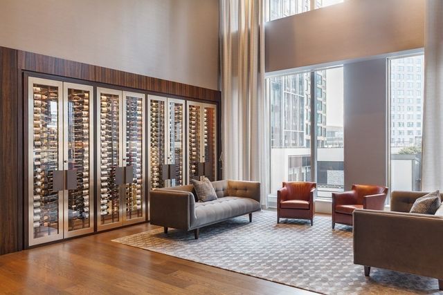 a living room with furniture and large windows