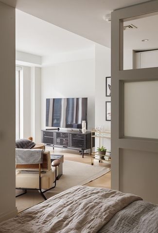 a living room with furniture and large window