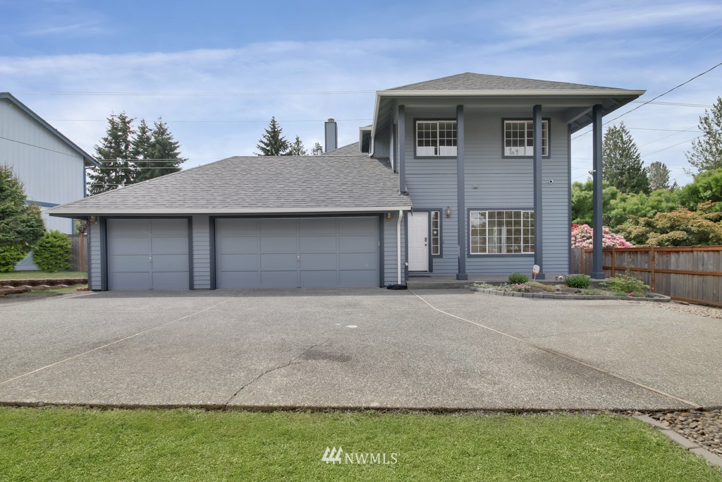 a front view of a house with a yard and garage