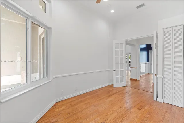a view of a hallway with wooden floor and staircase