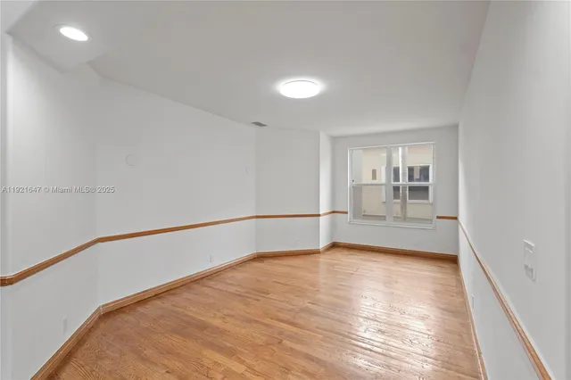 a view of swimming pool with lawn chairs and plants