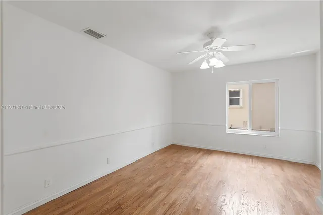 a view of swimming pool with outdoor seating and house in the background