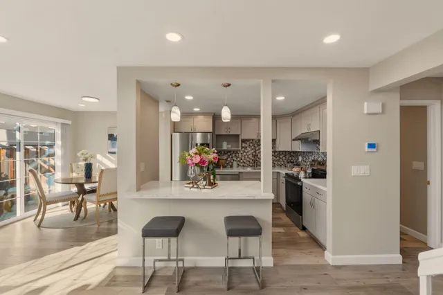 a kitchen with a sink a refrigerator and a stove